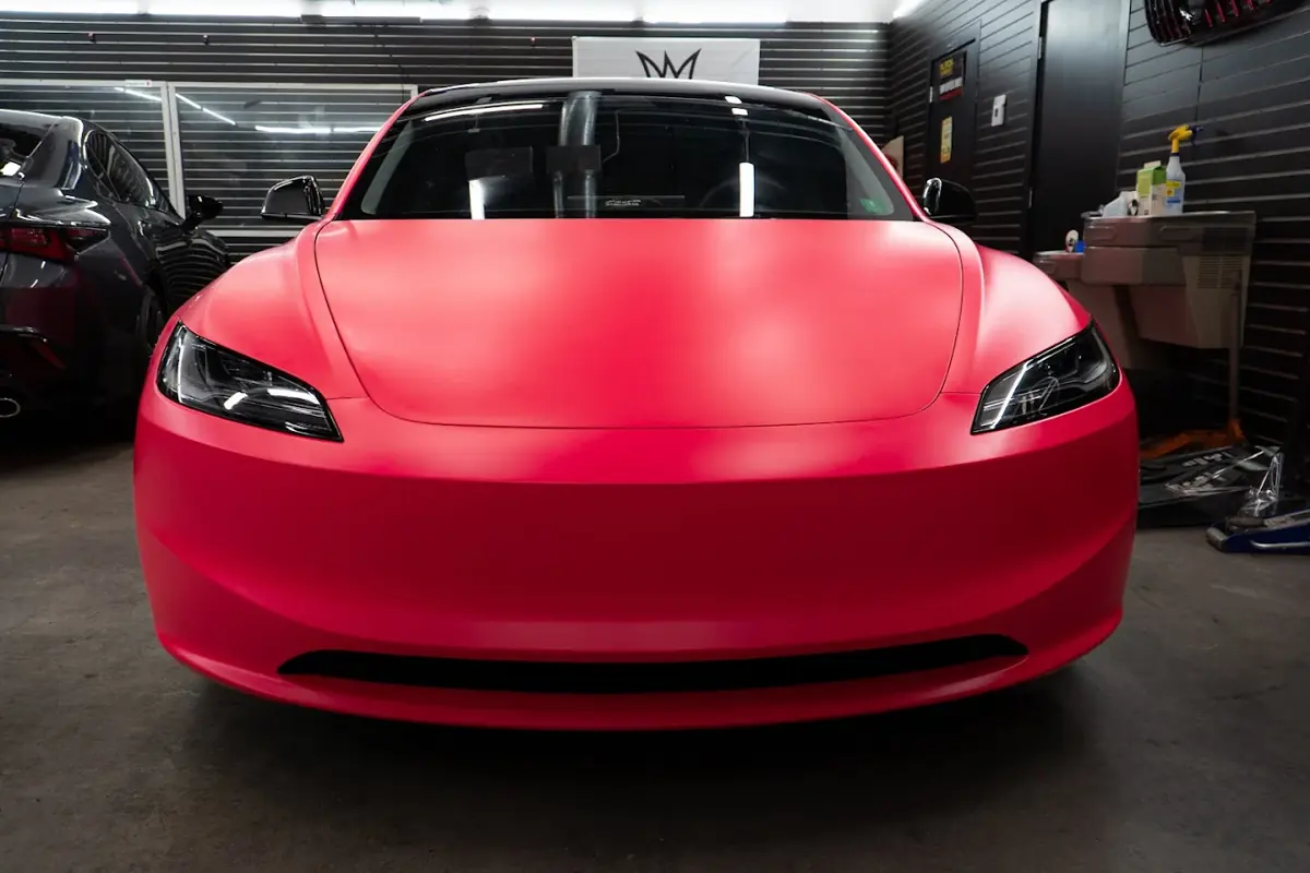 Tesla Model 3 in a coral wrap